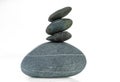 A pyramid of four stones in balance is isolated on a white background Royalty Free Stock Photo