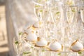 Pyramid from glasses of champagne and cakes on wedding party Royalty Free Stock Photo