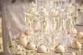 Pyramid from glasses of champagne and cakes on wedding party Royalty Free Stock Photo