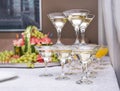 Pyramid of glasses of sparkling wine, fruit in the background Royalty Free Stock Photo