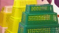 Pyramid of green and yellow plastic baskets. Royalty Free Stock Photo