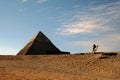 Pyramid of Khafre and camel rider in the sunset Royalty Free Stock Photo