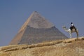 Pyramid of Khafre (Chephren) in Giza - Cairo, Egypt with a tourist police on a camel Royalty Free Stock Photo