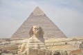 The pyramid of Khafre or of Chephren with a statue of a sphinx in the foreground Royalty Free Stock Photo