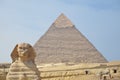 The pyramid of Khafre or of Chephren with a statue of a sphinx in the foreground Royalty Free Stock Photo