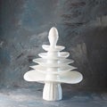 Pyramid made from white dishes, Christmas tree shape with egg on top on dark background. Creative concept about dishware, kitchen Royalty Free Stock Photo