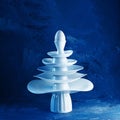 Pyramid made from white dishes, Christmas tree shape with egg on top on dark background. Creative concept dishware, kitchen, Royalty Free Stock Photo