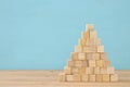 Pyramid made from wooden cubes. Royalty Free Stock Photo