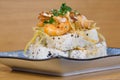 Pyramid of maki roll with fried shrimps, tempura vegetables, sesame and rocket decoration Royalty Free Stock Photo