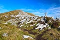 Pyramid with mascot shows direction on Alpine mountain peak