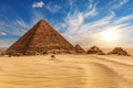 The Pyramid of Menkaure at sunset in Egypt and a camel nearby  Giza Royalty Free Stock Photo