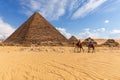 The Pyramid of Menkaure with three pyramids of the queens and bedouins near them