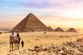 The Pyramid of Menkaure and tourists on camels, Giza, Egypt