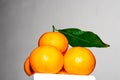 Orange pyramid with green leaves, drying.