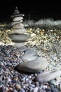 Pyramid from pebble on seacoast at night Royalty Free Stock Photo