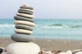 Pyramid of pebbles with a shell on top on the beach, close-up and free space for text, Cyprus Royalty Free Stock Photo