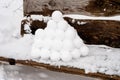 pyramid or a pile of perfect snowballs on frosty winter day in forest or garden outdoor.