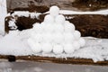 pyramid or a pile of perfect snowballs on frosty winter day in forest or garden outdoor.