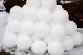 pyramid or a pile of perfect snowballs on frosty winter day in forest or garden outdoor.