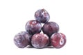 Pyramid pile of purple ripe plums on white background isolated close up macro