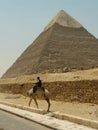 Pyramid and police guard on camel in Cairo Royalty Free Stock Photo