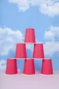 a pyramid of red disposable paper cups