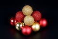 Pyramid from a red and gold shiny and matte christmas balls close up view