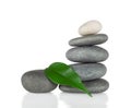 The pyramid of round stones with green leaf Royalty Free Stock Photo