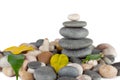 The pyramid of round stones with leaves Royalty Free Stock Photo