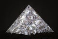 a pyramid scheme on black background. The concept of financial fraud. The dollar as a global financial pyramid