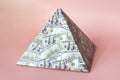 a pyramid scheme isolated on pink background. The concept of exchange in financial markets is the collapse of the financial system