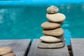 Pyramid of sea pebbles on the background of the pool. The concept of life balance and harmony. Copy of the space Royalty Free Stock Photo