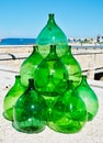 Pyramid set of vintage green glass large bottles demijohns for wine Royalty Free Stock Photo