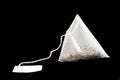 Pyramid shape tea bag isolated on black background with clipping path. Close-up of fresh herbal tea bag isolated over black Royalty Free Stock Photo