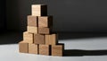 A pyramid shaped stack of wooden cubes is arranged on a flat surface Royalty Free Stock Photo