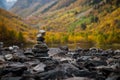 pyramid on the shore of a mountain lake in the autumn forest