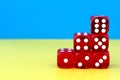 A pyramid of six dice for the game stands on yellow and blue. Royalty Free Stock Photo