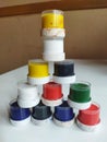 a pyramid of small cans of paint