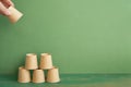 Pyramid stack of brown cup on wooden table. green background. business develop achievement growth concept Royalty Free Stock Photo