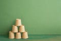 Pyramid stack of brown cup on wooden table. green background. business develop achievement growth concept Royalty Free Stock Photo