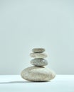 Pyramid of stacked stones. Small tower of rocks. Cairns of four pebbles. Harmony, zen, balance concept. Copy space