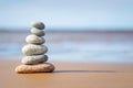 Pyramid stones balance on the sand of the beach. The object is in focus Royalty Free Stock Photo