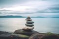 Pyramid stones balance on the sand of the beach. The object is in focus, the background is blurred. Neural network AI Royalty Free Stock Photo