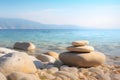 Pyramid stones balance on the sand of the beach. The object is in focus, the background is blurred. Neural network AI Royalty Free Stock Photo