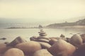 Pyramid stones balance on the sand of the beach. The object is in focus, the background is blurred. Neural network AI