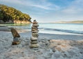 Pyramid stones balance on the sand of the beach. The object is in focus, the background is blurred Royalty Free Stock Photo