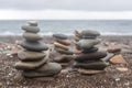 Pyramid stones balance on the sand of the beach. Royalty Free Stock Photo