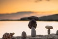 Pyramid stones balance on the sand of the beach. The object is in focus,sunset view. Royalty Free Stock Photo