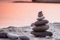 Pyramid stones balance on the sand of the beach. The object is in focus,sunset view. Royalty Free Stock Photo