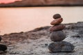 Pyramid stones balance on the sand of the beach. The object is in focus,sunset view. Royalty Free Stock Photo
